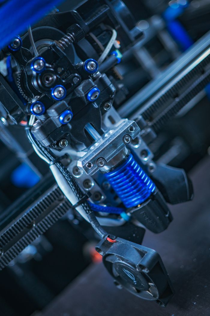 Detailed shot of a modern 3D printer's mechanical components, emphasizing technology.