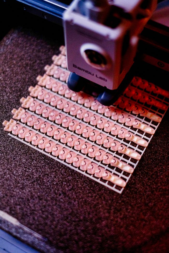 Close-up of a 3D printer creating intricate patterns. Focus on precision and technology.